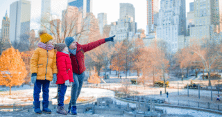 Family of father and kids in Central Park - Winter Break - iStock.com travnikovstudio