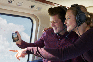 Couple in helicopter taking photos - iStock.com|MachineHeadz